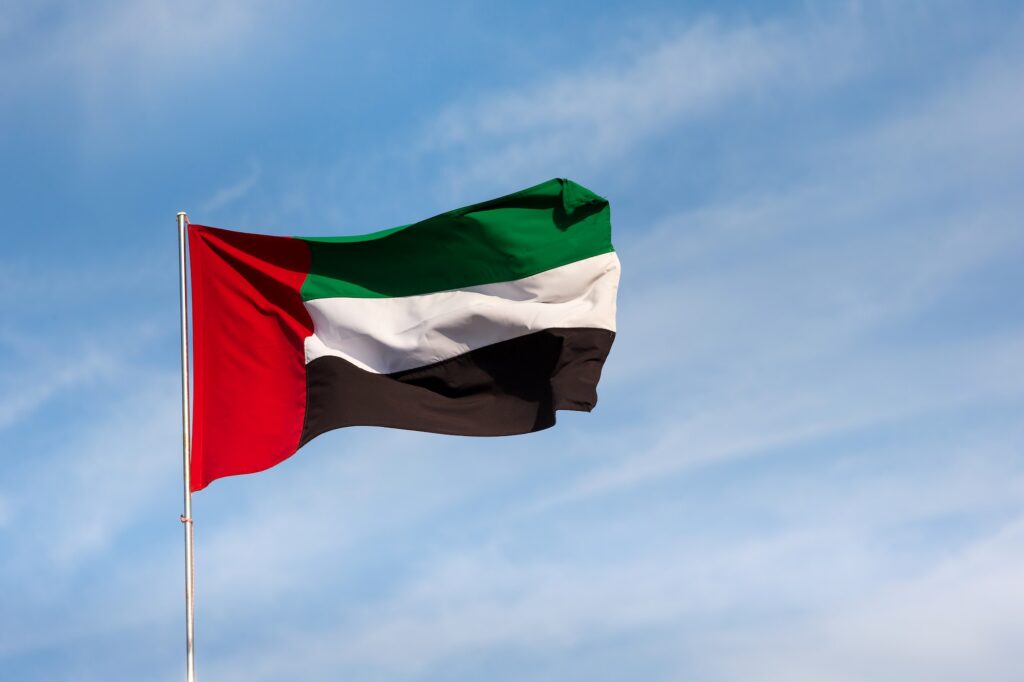 UAE flag waving in the sky, national symbol of UAE. UAE National day. UAE flag day.